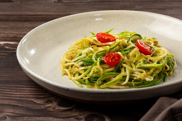 Zucchini spaghetti with tomatoes in garlic and oil.