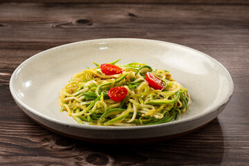 Zucchini spaghetti with tomatoes in garlic and oil.