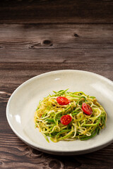 Zucchini spaghetti with tomatoes in garlic and oil.