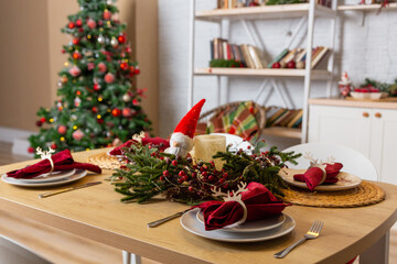 Beautiful table setting with Christmas decor in living room.