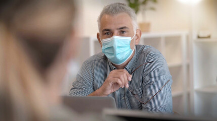 businessman wearing a mask on a date and presenting a project