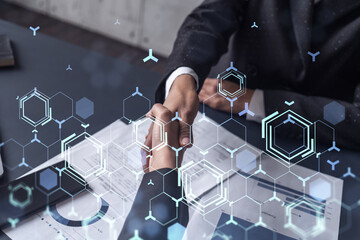 Handshake of two businesswomen who enters into the contract to develop a new software to improve...