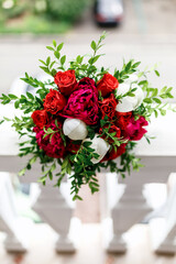 bouquet of red roses and red and white peonies