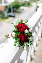 bouquet of red roses and red and white peonies