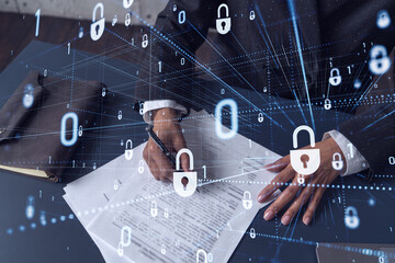 African American businesswoman in formal wear signing the contract to prevent probability of risks in cyber security. Padlock Hologram icons over the working desk. Women in business concept.