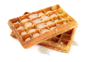 Two delicious Belgian waffles with honey on white background