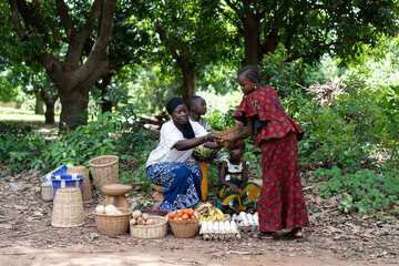 Typical West African street market scene with women selling vegetables