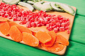 Mixture of dried fruit  on a colorful  wooden background.