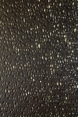 Translucent Glass Close-up Surface with Refractive Light. Uneven Bumpy Semitransparent Texture Background