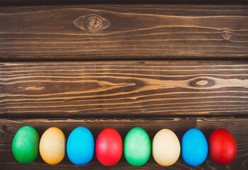 Easter eggs on rustic wooden table. Holiday background. 