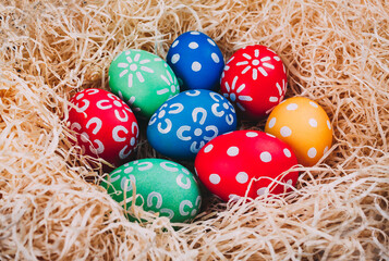 Perfect colorful handmade easter eggs in the nest