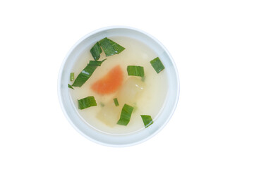 Above view of Hot broth sprinkled green vegetables with and carrots. Inside white cup. On isolated white background with clipping path.
