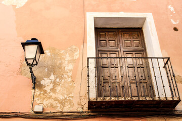 Old house facade with vintage streetlight