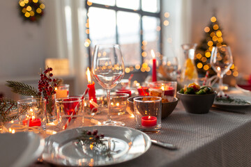 eating, winter holidays and celebration concept - close up of table serving for christmas dinner...