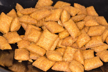 Dry cat food in a plastic bowl close-up