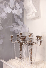 Vintage metal candlesticks in a snowy interior. Christmas background