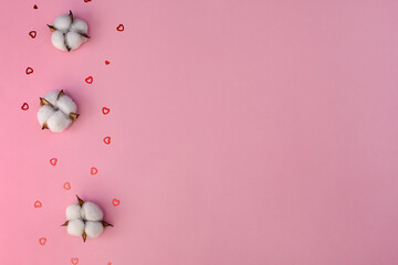 layout. Cotton flowers and small hearts on a pink background. Congratulations on wedding, on Valentine's Day. copy space. 