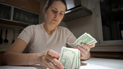 Young woman getting financial or tax report and counting money. Concept of financial difficulties, bankruptcy, taxes and rent payment.