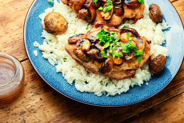 Chicken meat with mushroom sauce and rice