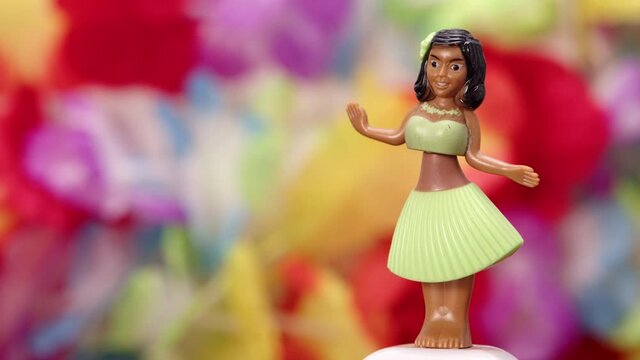 Traditional hawaiian hula dancer doll on multi colored background