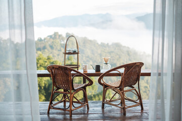 arabica coffee brewing by Vintage coffee drip equipment set on wooden table in the morning with mountain at countryside homestay