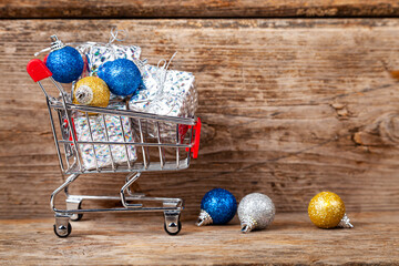Shopping cart with Christmas gifts and balls