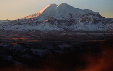Beautiful photography of the mountain Elbrus in the morning. Autumn weather, nature travel in Russia. Sunny outdoor scenics.
