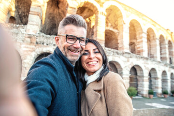 Married couple of tourists taking a selfie portrait visiting Italy - Senior man and woman enjoying...