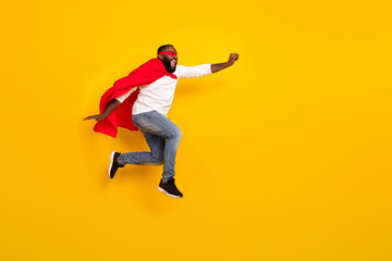 Fototapeta na wymiar Full size profile photo of carefree strong hero raise fist empty space flight hurry isolated on yellow color background