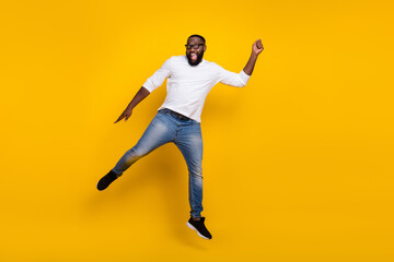 Fototapeta na wymiar Full length photo of crazy handsome guy arm hold empty space umbrella isolated on yellow color background