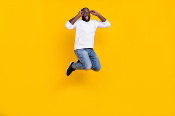 Fototapeta na wymiar Full body portrait of excited cheerful person arms touch spectacles have fun isolated on yellow color background