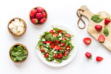 Vegetarian lunch spinach and strawberry salad. Top view