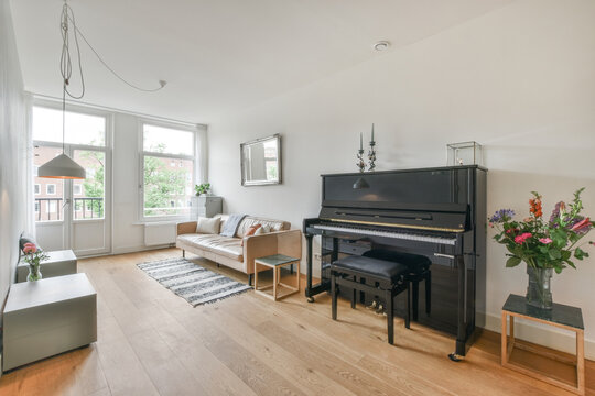 Interior of living room with piano and sofa
