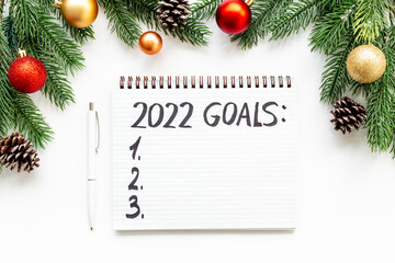 Fototapeta na wymiar New year goals and resolutions concept. Hand writing text on notebook, top view