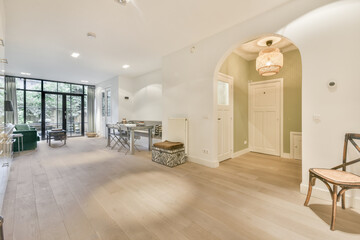 Interior of spacious hall and living room with arched doorway