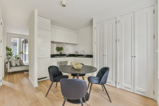 Dining area of modern kitchen with round table and chairs