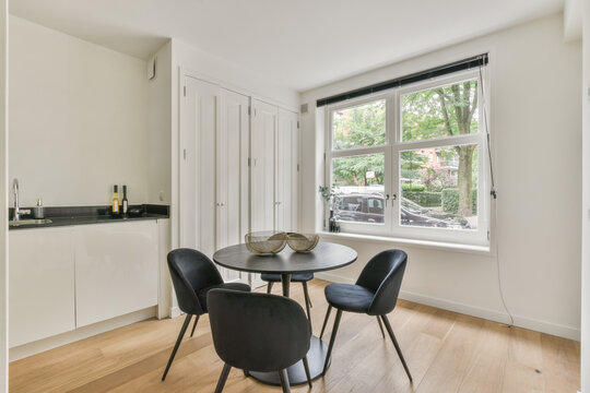 Dining area of modern kitchen with round table and chairs