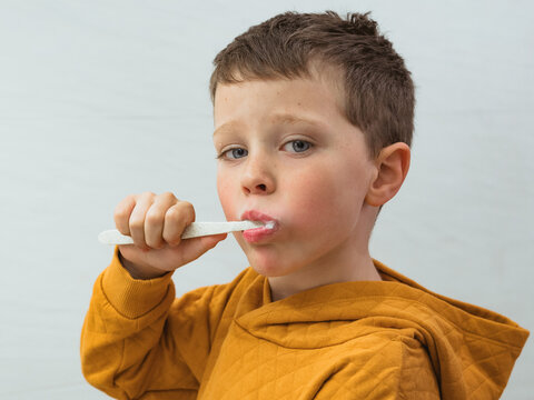 Boy brushing teeth in bathroom