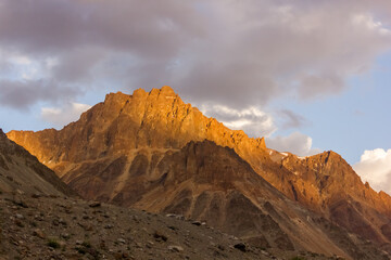 Evening light hitting the barren brown mountains of the Zanskar range in the Himalayan region of Ladakh.