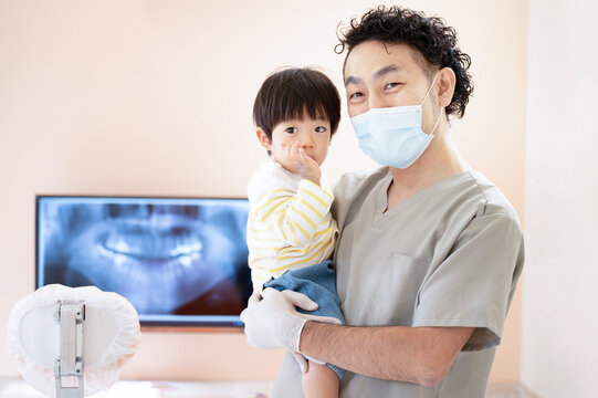 Image of a gentle pediatric dentist looking at the camera