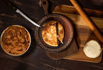  Prepared homemade pie with minced meat filling on the kitchen table