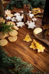Different homemade christmas cookies on brown vintage wood. Vertical background with short depth of field for the sweet christmas baking.