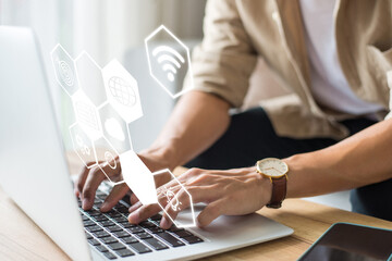 Young businessman touching and tying on computer laptop start new project with icon business and network connection on modern virtual interface from laptop.