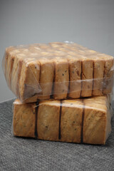 top view of sweet cookies in a plastic packet on wooden table 