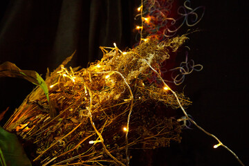 Christmas lights in a dark room. Lights at Christmas and New Year indoors