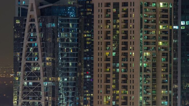 Night view of exterior apartment colorful buildings timelapse with windows