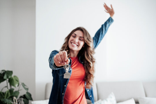 Happy Woman Holding House Keys At Home