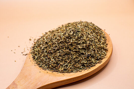 Dried oregana flakes wooden spoon