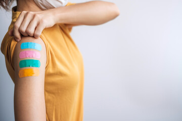 woman showing plaster after receiving covid 19 vaccine. Vaccination, herd immunity, side effect,...