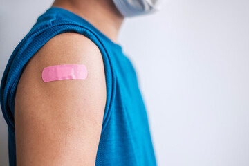 man showing bandage after receiving covid 19 vaccine. Vaccination, herd immunity, side effect, booster dose, vaccine passport and Coronavirus pandemic